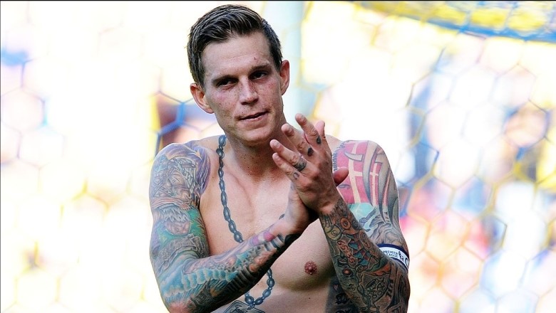 Agger had striking, colorful tattoos across his back