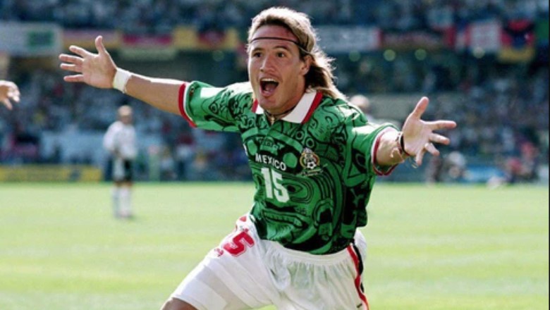 Vibrant Aztec Sun Stone watermarks transformed this 1998 shirt into a global cultural artifact